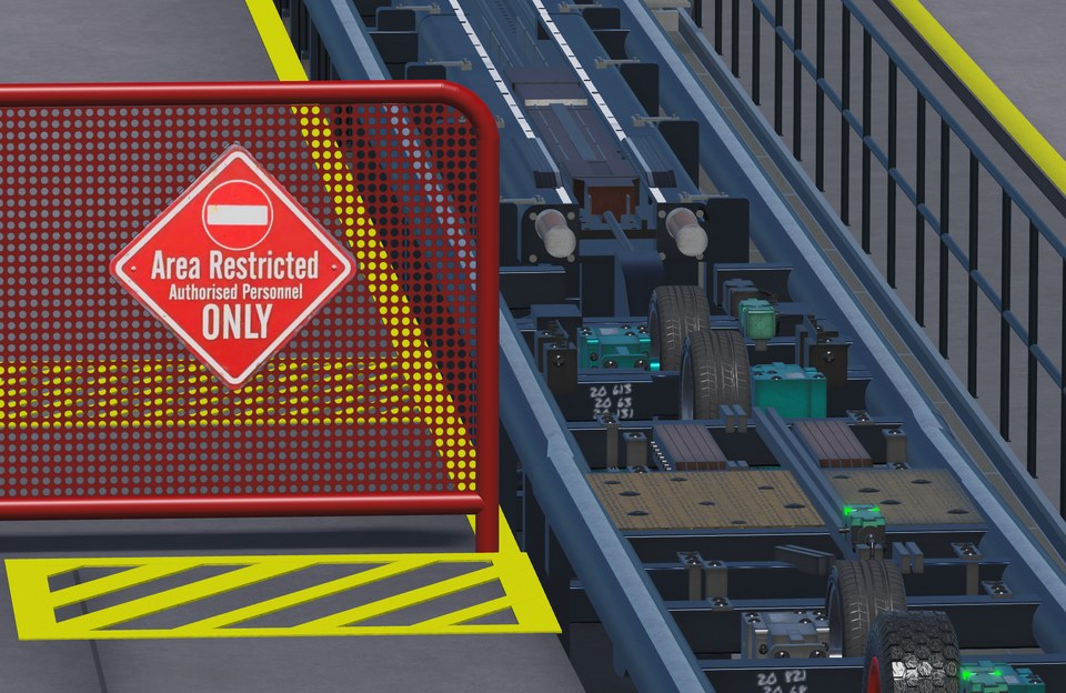 Coaster station drive assemblies beside red restricted-access mesh gate and yellow markings