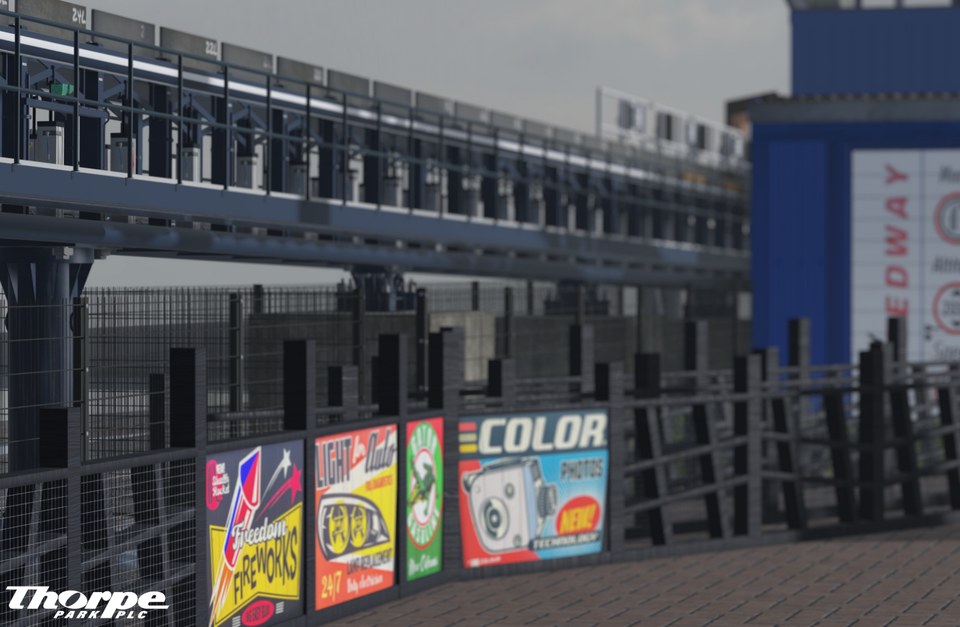 Exterior of a recreated coaster station with glazed upper level, railings and colourful posters
