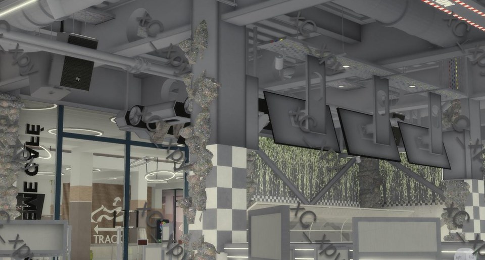 Café Xtreme interior angle showing overhead monitors, checkerboard column and ceiling pipes